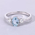 0.60 Ct Oval Blue Aquamarine and Lab Diamond Prong Silver Three Stone Ring by Fine Color Jewels