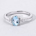 0.60 Ct Oval Blue Aquamarine and Lab Diamond Prong Sterling Silver Bypass Ring by Fine Color Jewels