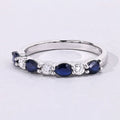 0.80 Ct Pear Blue Sapphire and Lab Diamond Prong Silver Seven Stone Half Eternity Ring by Fine Color Jewels