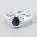 0.80 Ct Pear Blue Sapphire & Lab Diamond Prong Silver Halo Ring by Fine Color Jewels