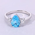 1.30 Ct Pear Swiss Blue Topaz and Lab Diamond Prong Silver Three Stone Ring by Fine Color Jewels