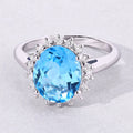 4 Ct Oval Swiss Blue Topaz and Lab Diamond Prong Silver Halo Ring by Fine Color Jewels