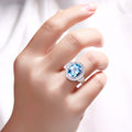 4 Ct Oval Swiss Blue Topaz and Lab Diamond Silver Halo Statement Ring by Fine Color Jewels