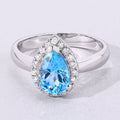 1.30 Ct Oval Swiss Blue Topaz & Lab Diamond Prong Silver Halo Engagement Ring by Fine Color Jewels