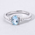 0.60 Ct Oval Blue Aquamarine and Lab Diamond Prong Sterling Silver Bypass Ring by Fine Color Jewels