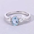 0.60 Ct Oval Blue Aquamarine and Lab Diamond Prong Silver Three Stone Ring by Fine Color Jewels