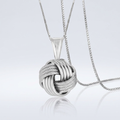Sterling Silver Pendant with a Ridge Textured Love Knot Design by Avera Group