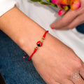 Lucky Ladybug - Four-Strand Red String Bracelet by Conscious Items