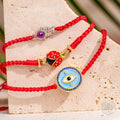Lucky Ladybug - Four-Strand Red String Bracelet by Conscious Items