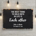The Best Thing To Hold Onto Life Is Each Other Sign by Tailored Canvases